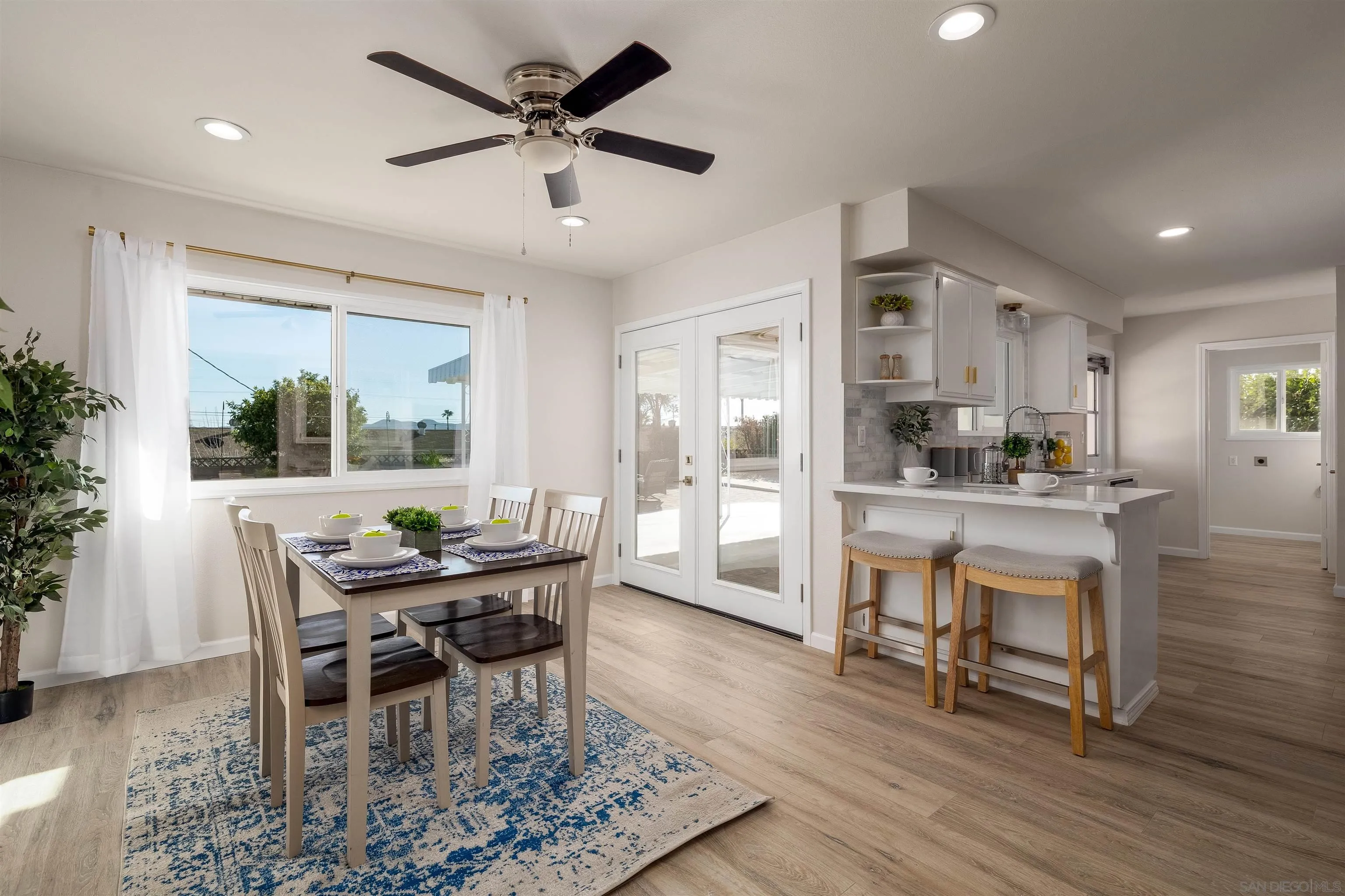 27431 El Rancho Road Menifee, CA 92586 - Photo 20 of 39 a dining room with furniture a window and wooden floor