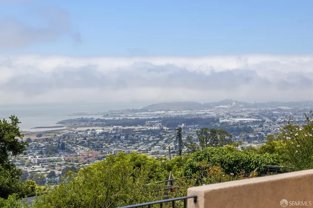 an aerial view of residential building and trees around