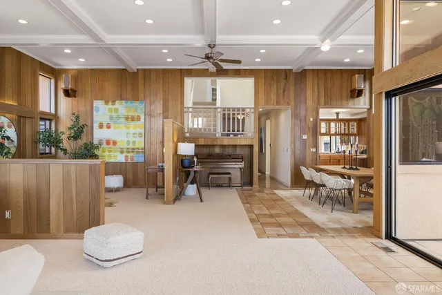 a living room with furniture a rug and kitchen view