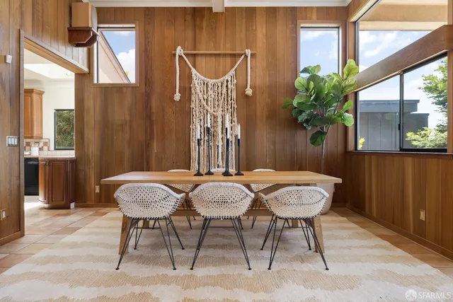 a view of a dining room with furniture and window