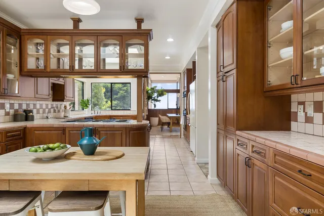 a view of a dining room with furniture a chandelier and wooden floor