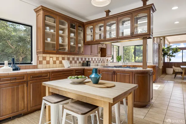 a view of a dining room with furniture a chandelier and wooden floor