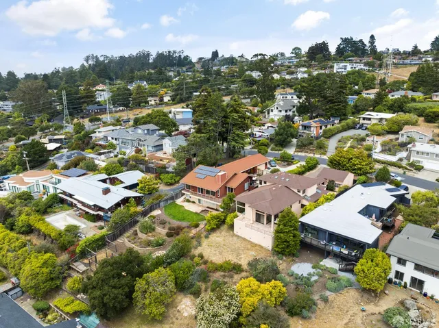 an aerial view of residential houses with outdoor space