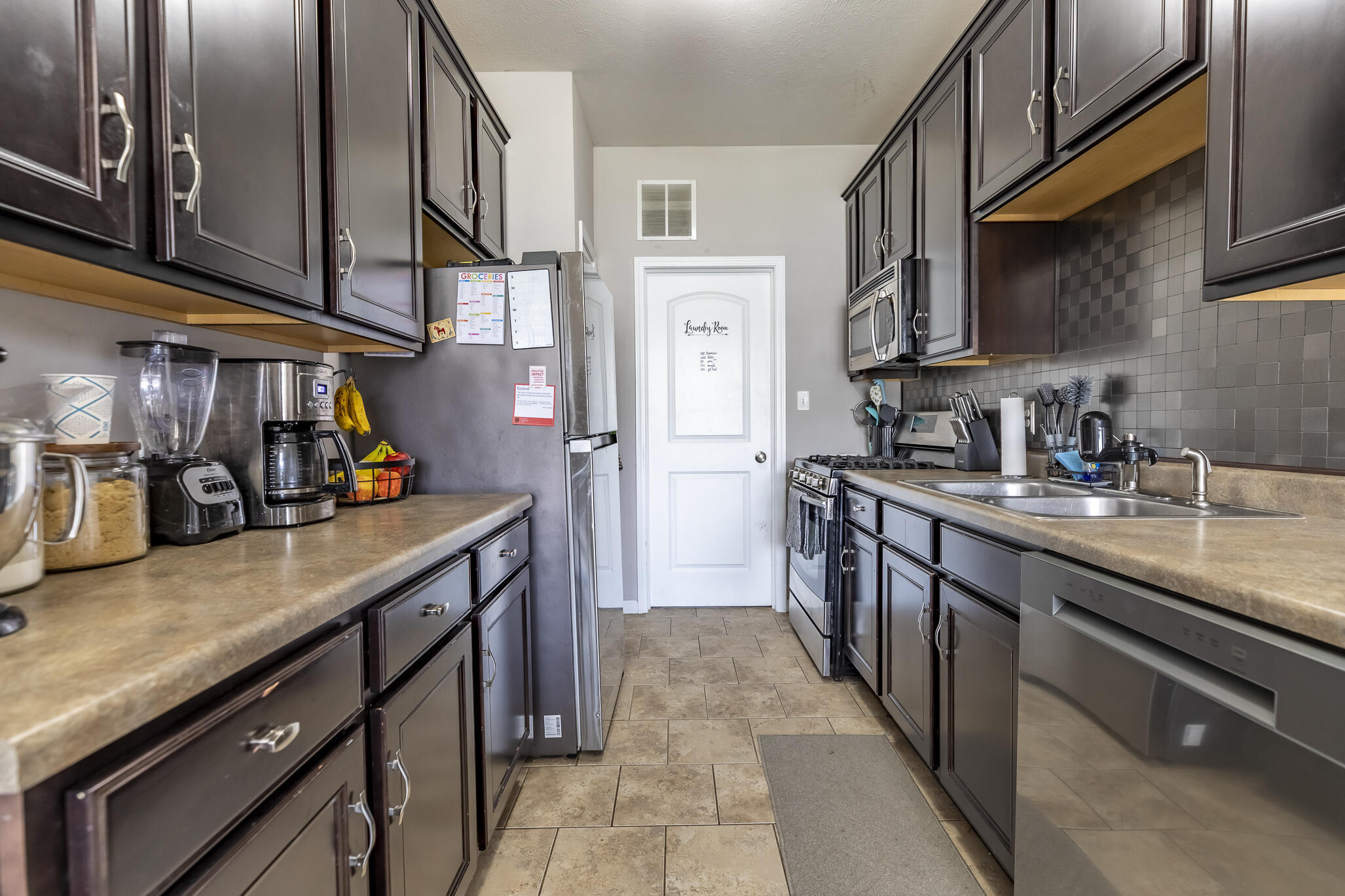 11527 Rhode Island Street Crown Point, IN 46307 - Photo 6 of 17 a kitchen with stainless steel appliances granite countertop a sink a stove and a refrigerator