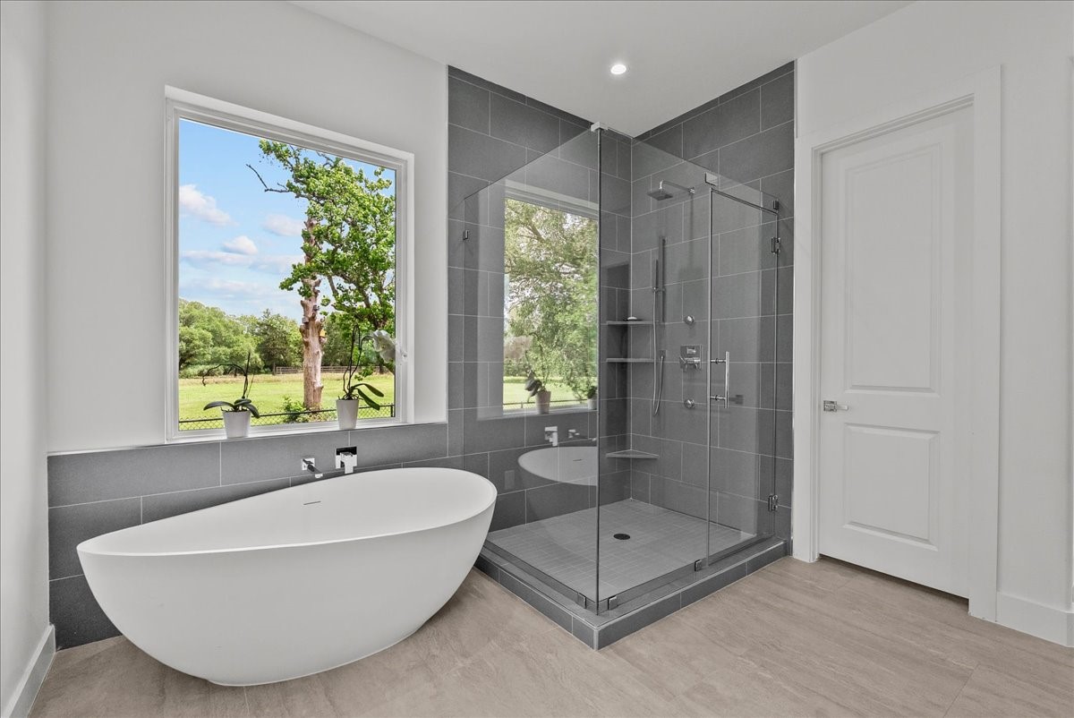7627 Scott Avenue Manvel, TX 77578 - Photo 26 of 50 Massive freestanding tub with natural views and a well equipped glass enclosed spacious walk-in shower.