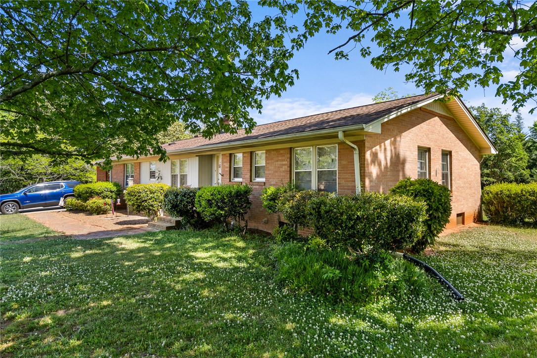 636 College Street Central, SC 29630 - Photo 2 of 2 This classic brick residence offers curb appeal and a serene outdoor setting.