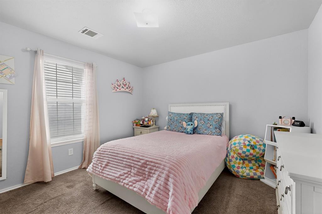 3825 Clay Mathis Road Mesquite, TX 75181 - Photo 25 of 39 a bedroom with a bed and a window
