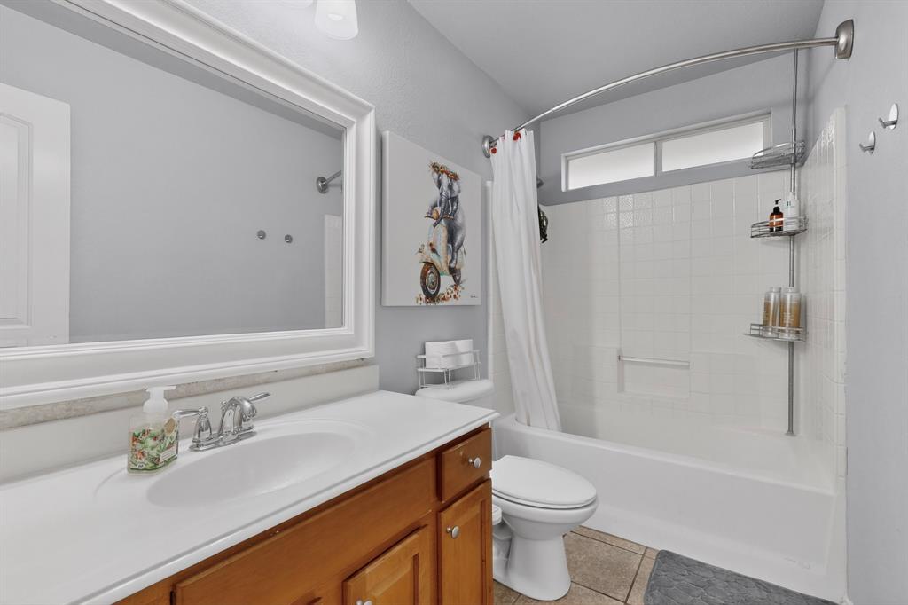 3825 Clay Mathis Road Mesquite, TX 75181 - Photo 26 of 39 a bathroom with a sink a toilet and shower