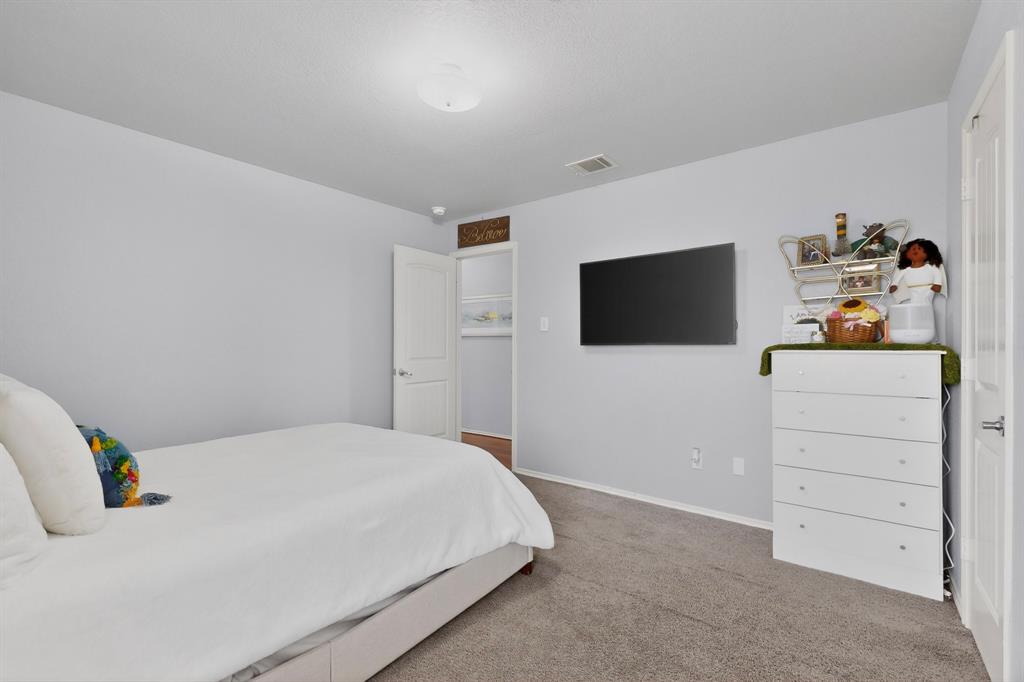3825 Clay Mathis Road Mesquite, TX 75181 - Photo 28 of 39 a bedroom with a bed and a flat screen tv