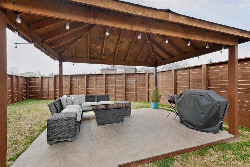 3825 Clay Mathis Road Mesquite, TX 75181 - Photo 3 of 39 a balcony with furniture and umbrella