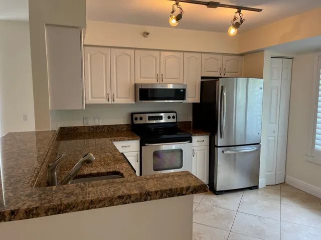 a kitchen with a refrigerator sink and microwave