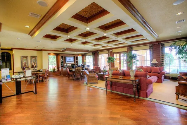 a living room with lots of furniture and kitchen view