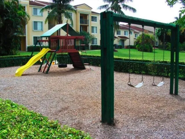 a view of playground with a slide and swing