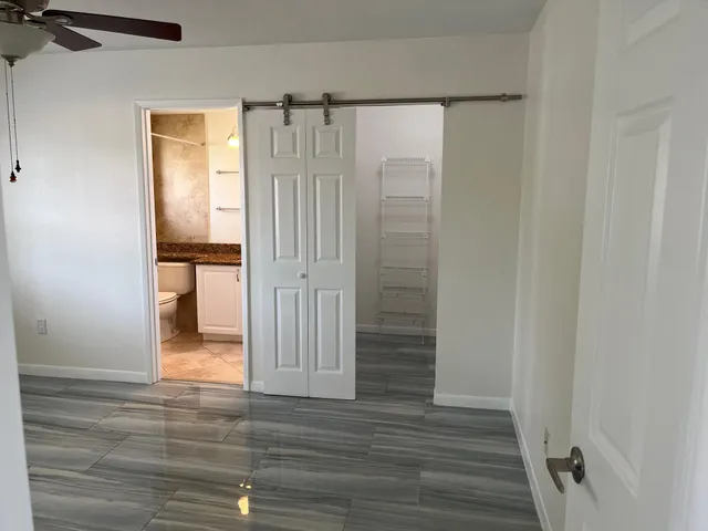 a view of a bathroom with wooden floor and a bathroom