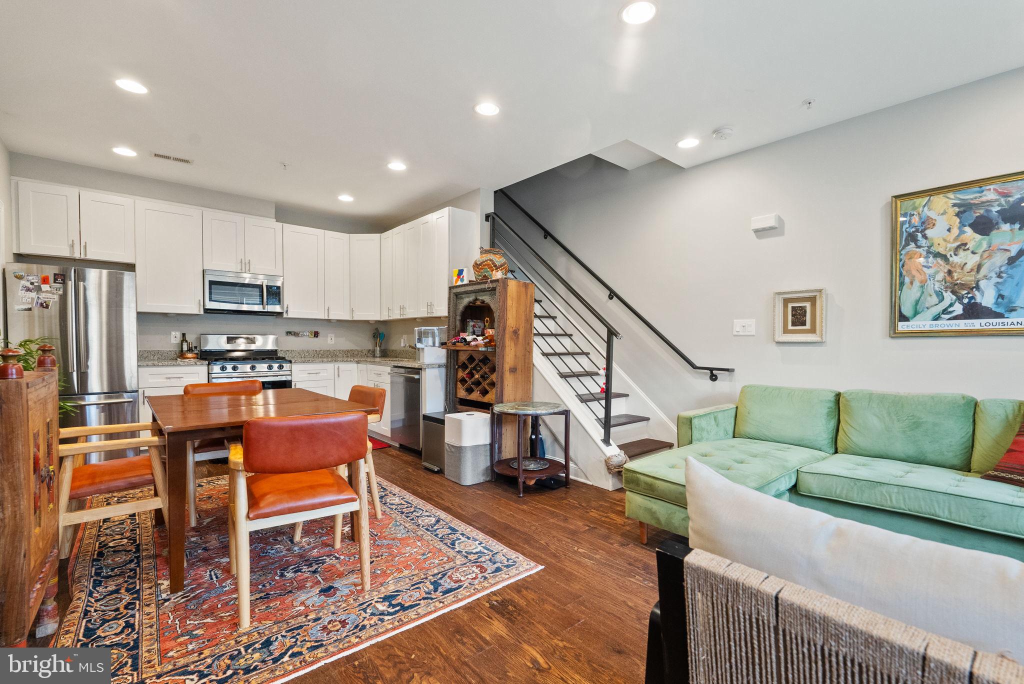 1018 13th Street Southeast, Unit 2 Washington, DC 20003 - Photo 11 of 30 a living room with furniture and a dining table with kitchen view