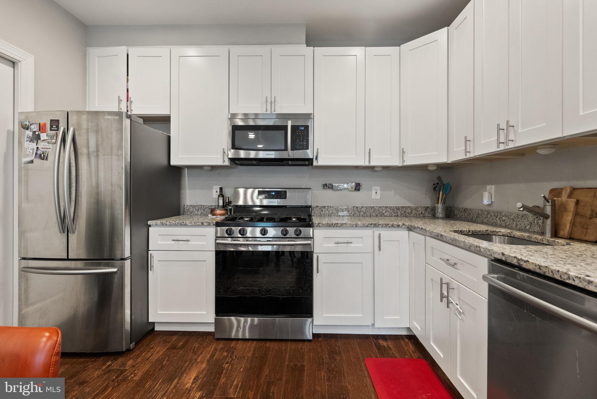 1018 13th Street Southeast, Unit 2 Washington, DC 20003 - Photo 14 of 30 a kitchen with stainless steel appliances granite countertop a refrigerator stove and white cabinets