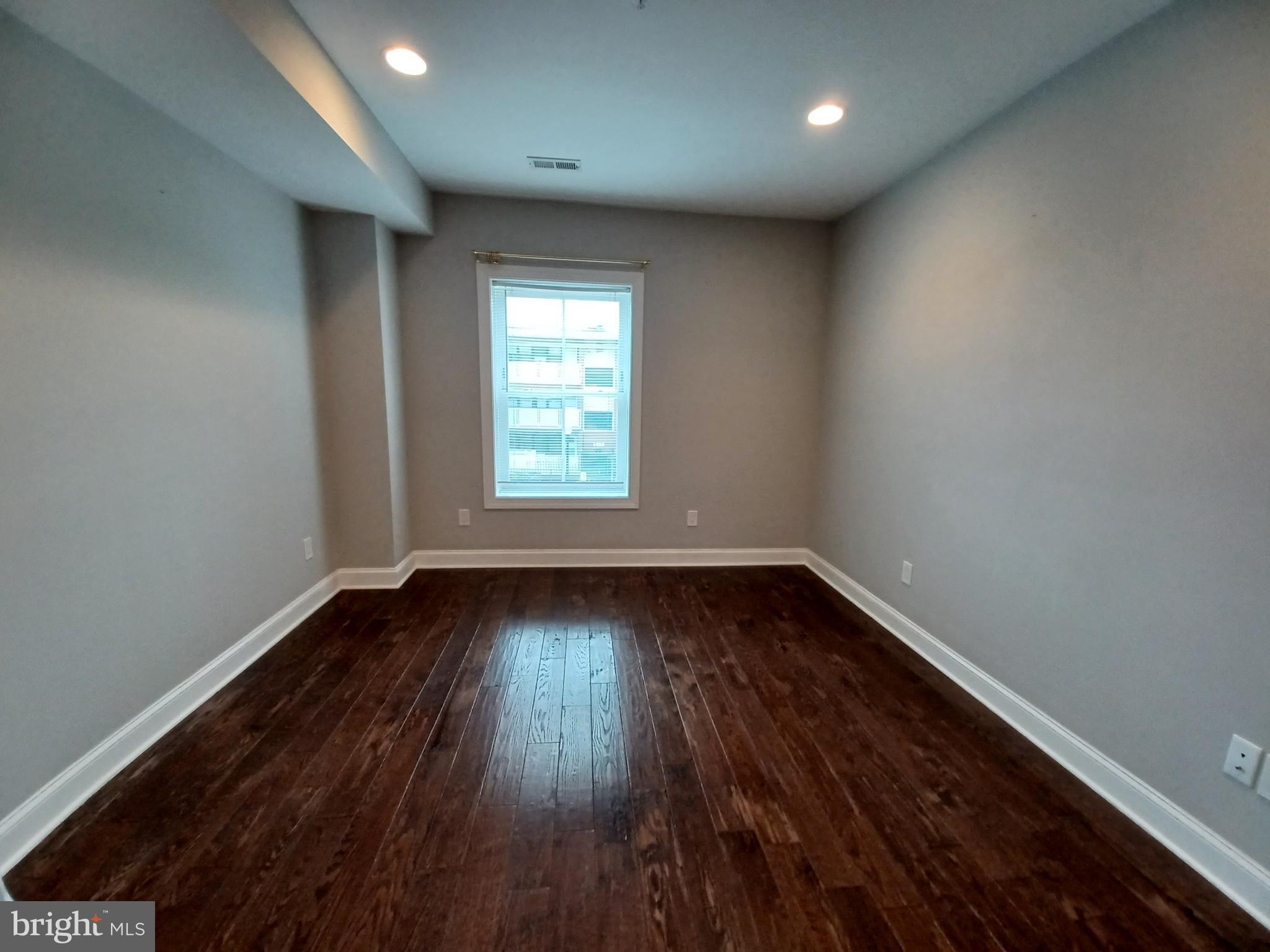 1018 13th Street Southeast, Unit 2 Washington, DC 20003 - Photo 23 of 30 an empty room with wooden floor and windows