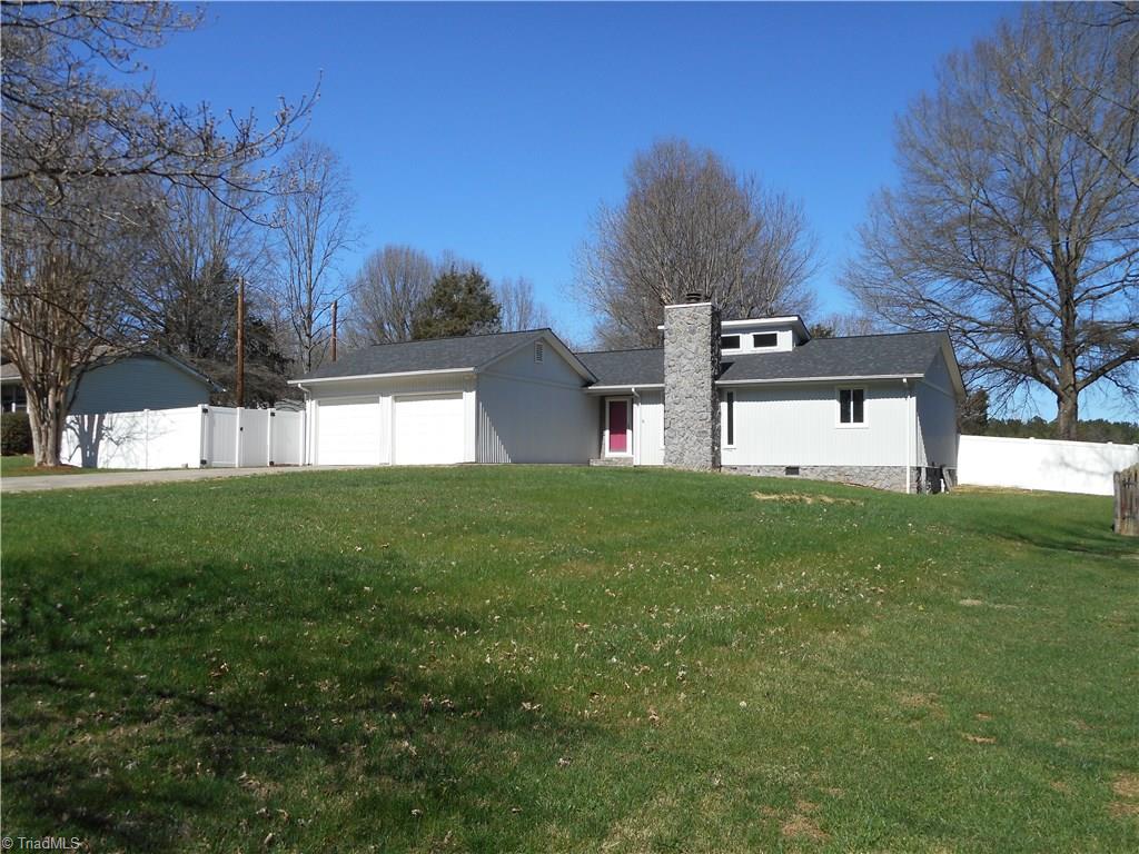 5929 Styers Ferry Road Clemmons, NC 27012 - Photo 11 of 28 In this right side view we can see a bit more on how the home was designed and built. You can see the entry area through the vinyl fence just to the left of the garage.