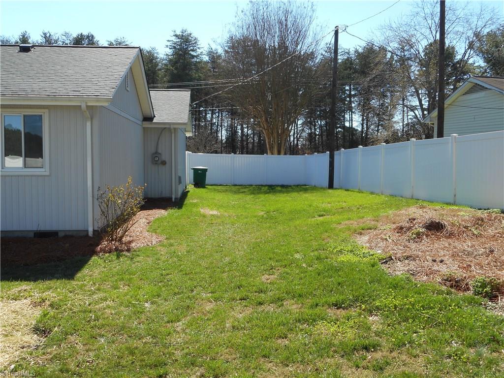 5929 Styers Ferry Road Clemmons, NC 27012 - Photo 17 of 28 In this photo we have the left side rear view of the home. This view shows you have some extra yard area then you initially thought you had.
