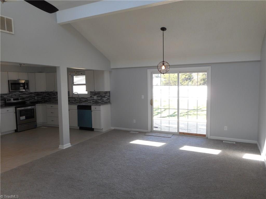 5929 Styers Ferry Road Clemmons, NC 27012 - Photo 3 of 28 In this view we can see the open dining room kitchen area from the living room. The dining room has new carpet, fresh new paint a sliding door out to the deck. You also have the vaulted ceiling.