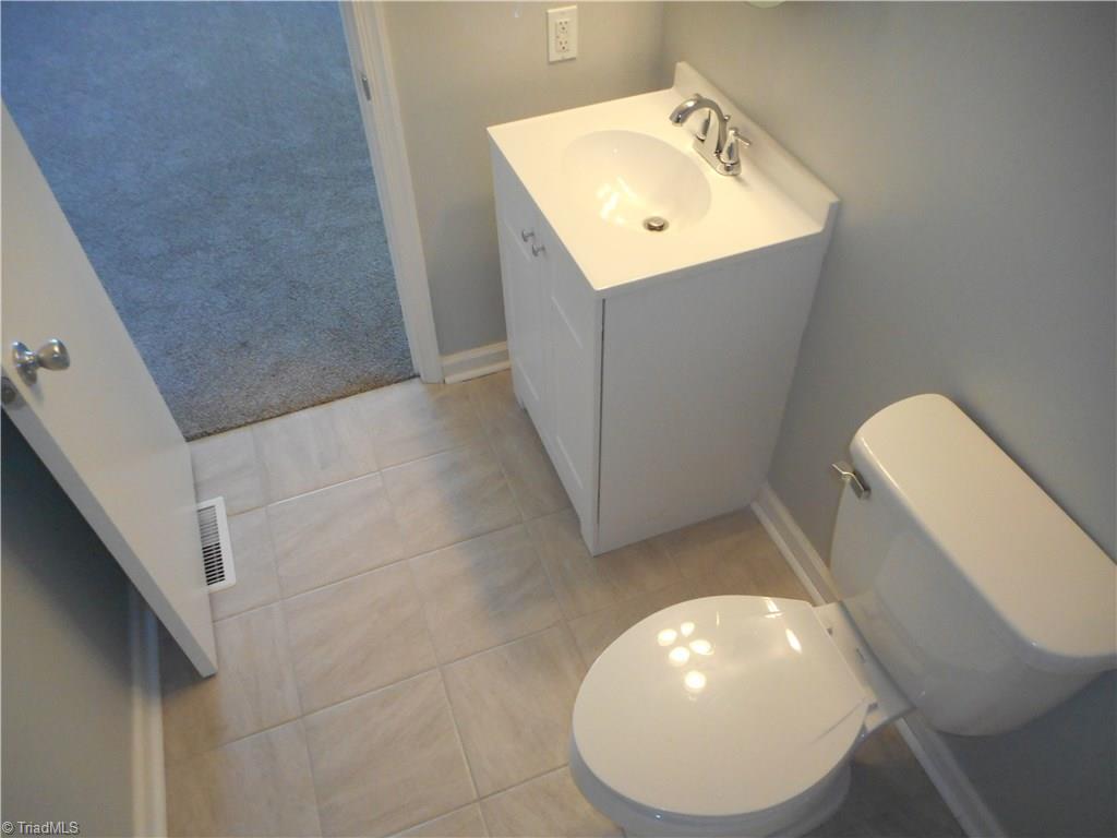 5929 Styers Ferry Road Clemmons, NC 27012 - Photo 21 of 28 Here in this view of the master bathroom from then tub side we have a better view of the new fixtures, the tile flooring for easy cleaning and the fresh new paint.