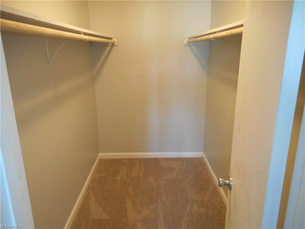 5929 Styers Ferry Road Clemmons, NC 27012 - Photo 22 of 28 Here we have a peak at the master bedroom WIC with the two built in shelves and plenty of room for all your clothes.