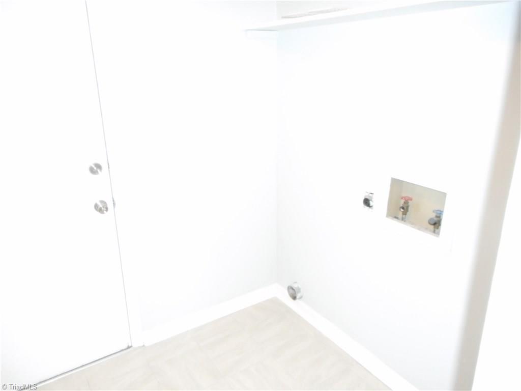 5929 Styers Ferry Road Clemmons, NC 27012 - Photo 27 of 28 In this view we are in the laundry room. Here we have the garage door on the left, tile flooring for easy cleaning, fresh new paint and all the hookups for the washer and dryer.