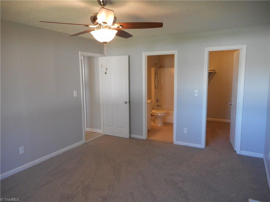 5929 Styers Ferry Road Clemmons, NC 27012 - Photo 5 of 28 Here in the master bedroom, we can see the entry doorway on the left, the master bathroom in the middle, and the large WIC on the right. This room also has fresh new paint and the ceiling fan with light.