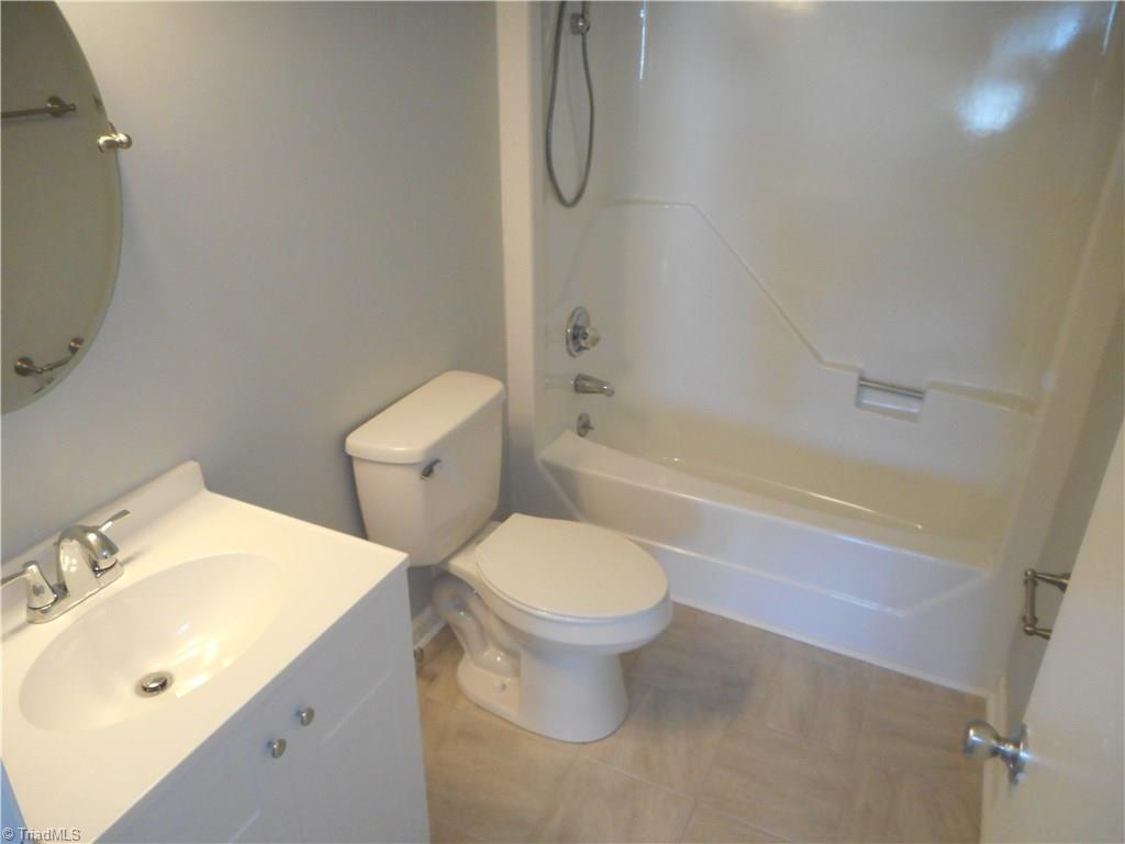 5929 Styers Ferry Road Clemmons, NC 27012 - Photo 6 of 28 Here in the master bathroom we have tile flooring for easy cleaning, a new vanity and fixtures.
