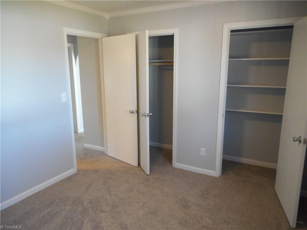 5929 Styers Ferry Road Clemmons, NC 27012 - Photo 9 of 28 Here we are in bedroom three looking out toward the entryway door from the main hall. We can see the new carpet flooring, fresh new paint and the double closets. The closet on the right has built in shelves for extra storage space.