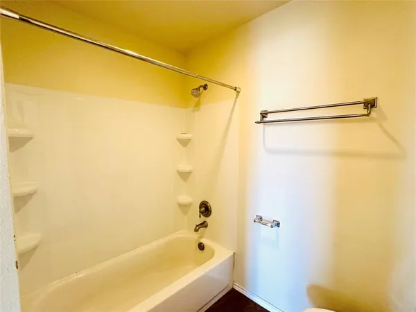 a bathroom with a shower and a bath tub