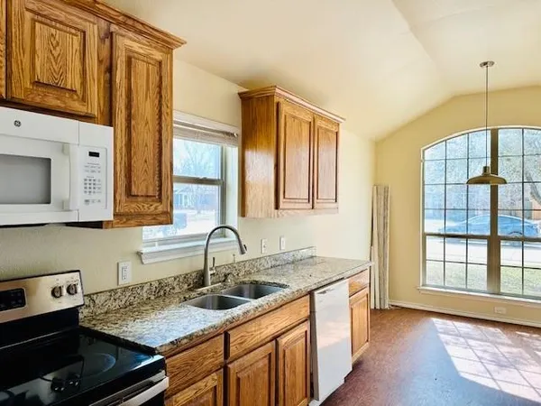 a kitchen with a sink stove and cabinets