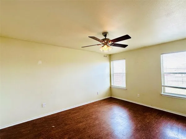 a view of a room with wooden floor and windows