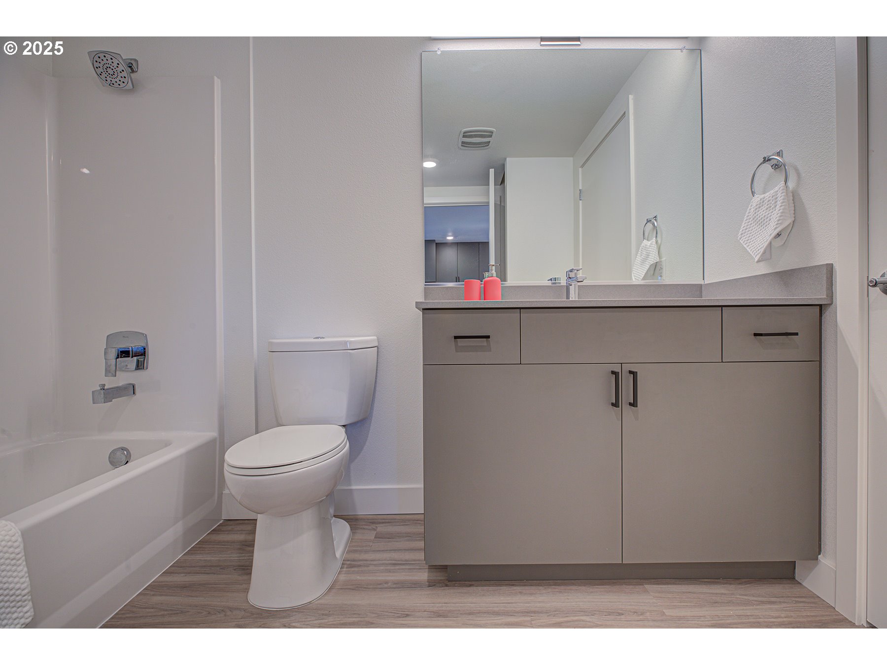 9757 Southeast Holgate Boulevard Portland, OR 97266 - Photo 12 of 16 a bathroom with a sink a toilet and a bathtub