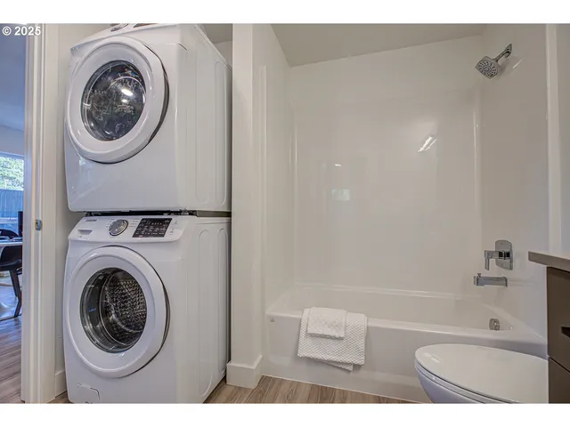 a bathroom with a bathtub and a washer