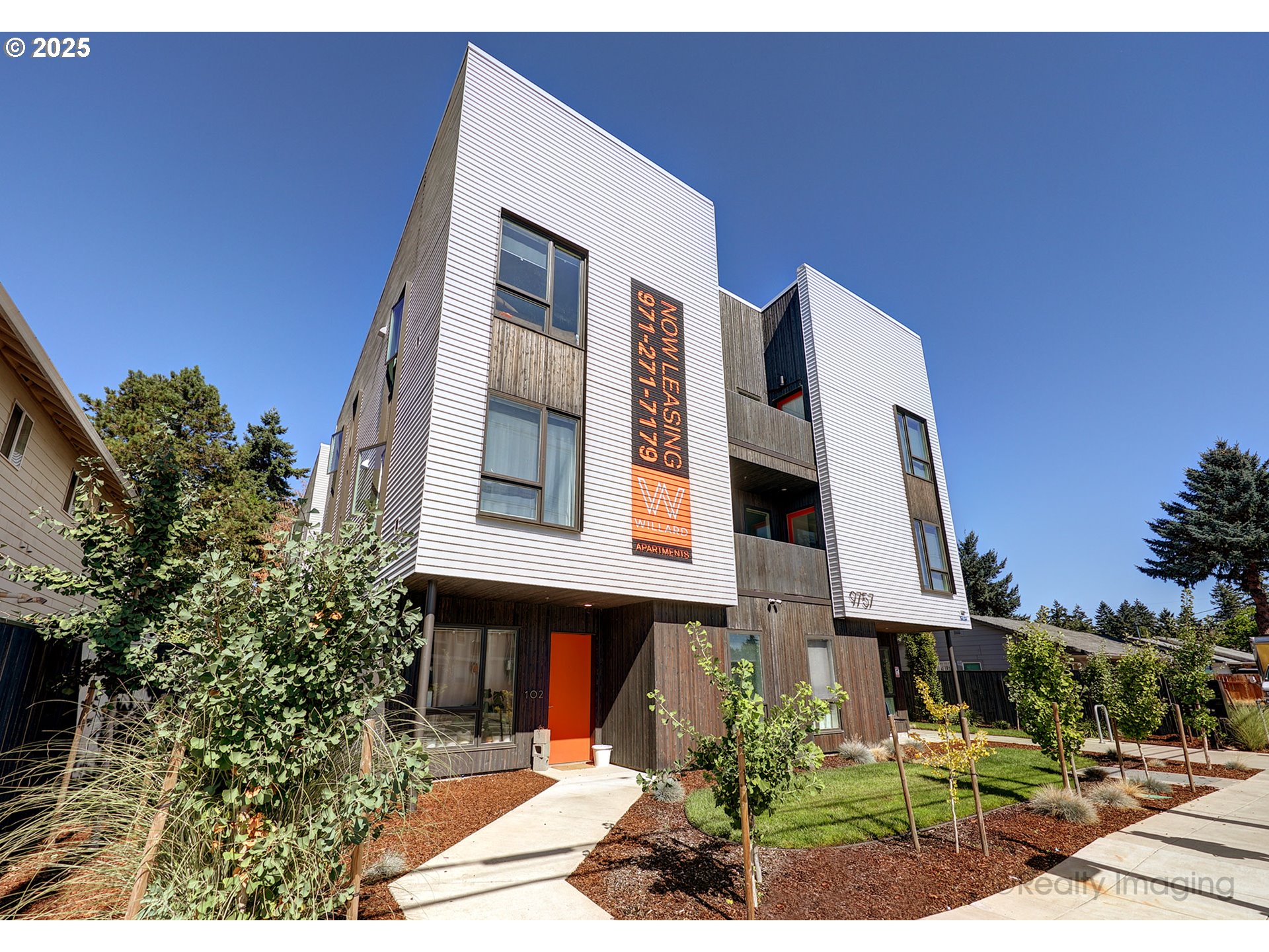 9757 Southeast Holgate Boulevard Portland, OR 97266 - Photo 3 of 16 a front view of a house with a garden