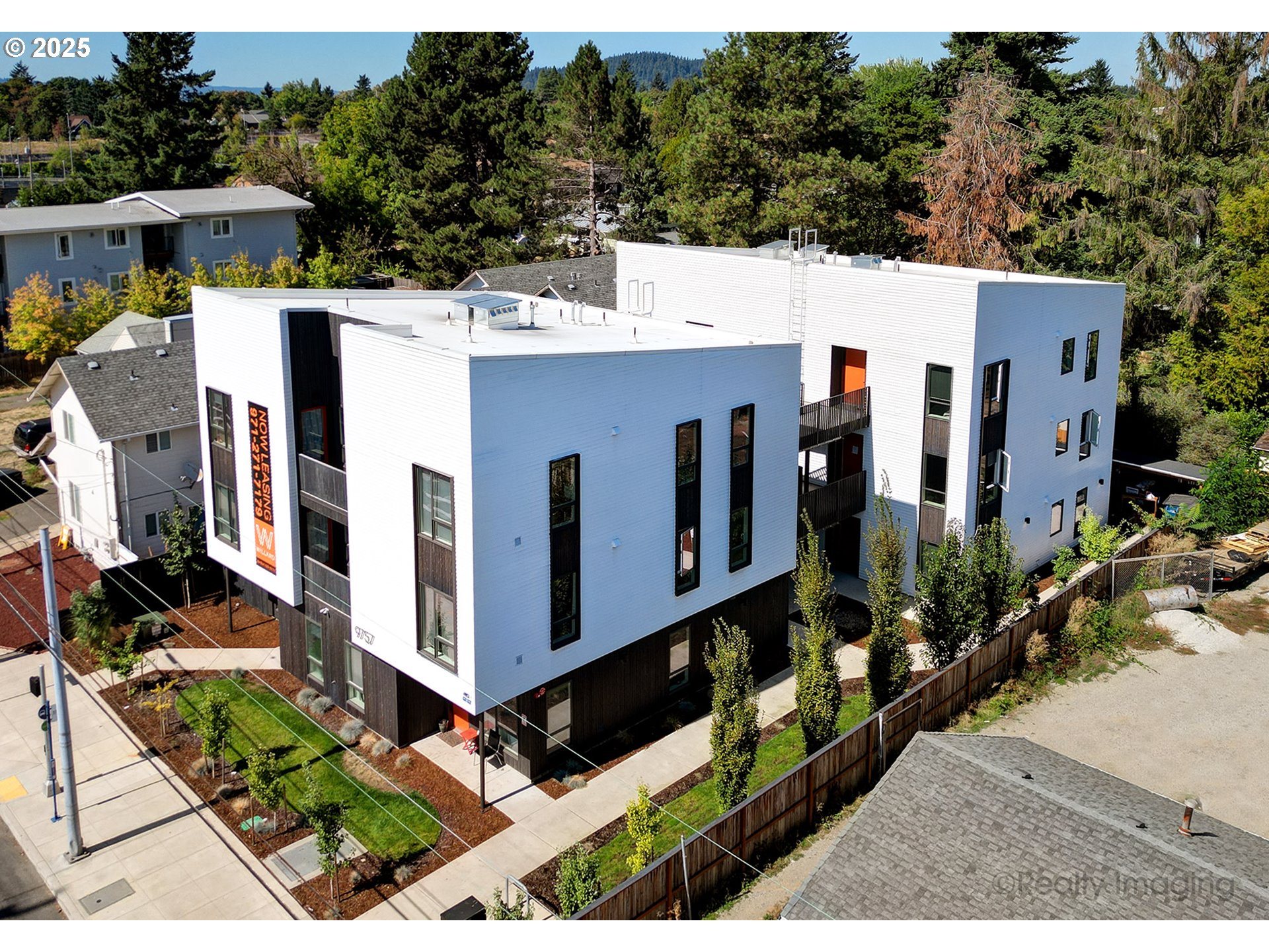 9757 Southeast Holgate Boulevard Portland, OR 97266 - Photo 5 of 16 a view of a large building with wooden fence