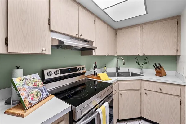 a kitchen with a stove and white cabinets