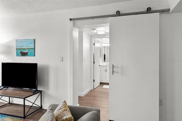 a view of a livingroom with furniture and a flat screen tv