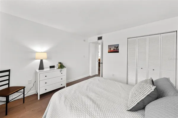a spacious bedroom with a bed and a window