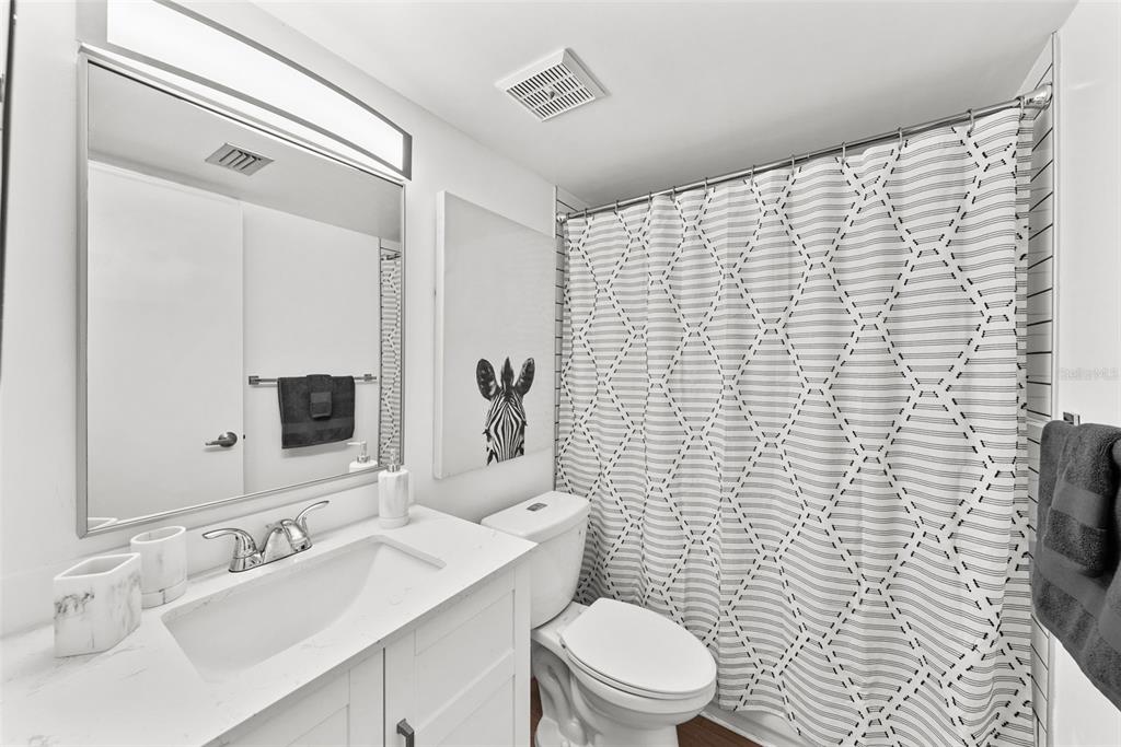 100 Waverly Way, Unit 403 Clearwater, FL 33756 - Photo 26 of 49 a bathroom with a sink a toilet and mirror