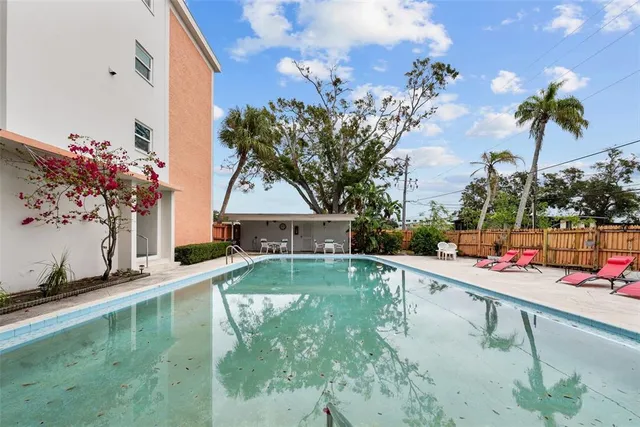 a front view of a building with garden and plants