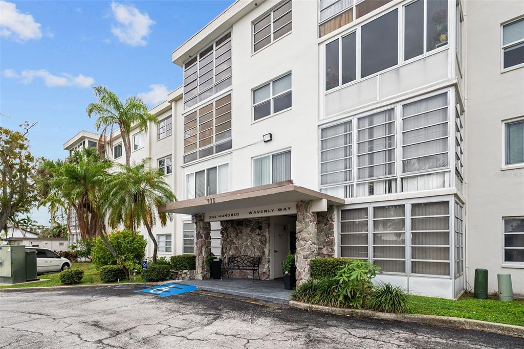 100 Waverly Way, Unit 403 Clearwater, FL 33756 - Photo 37 of 49 a front view of a building with garden and plants