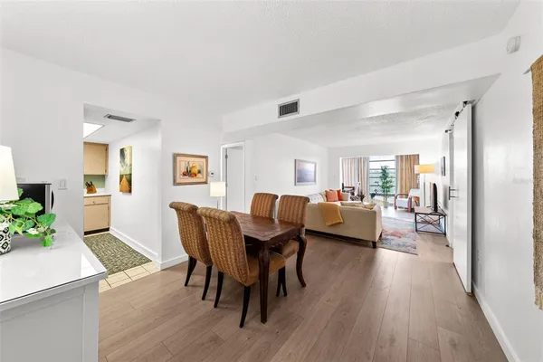 a view of a dining room with furniture and wooden floor