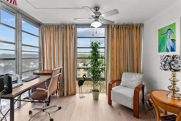 a view of a livingroom with workspace and a window