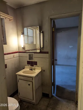 a bathroom with a sink a toilet and mirror