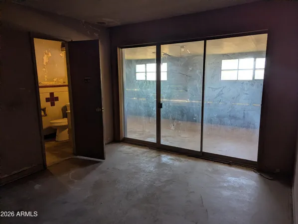 an empty room with sliding glass door and mountain view