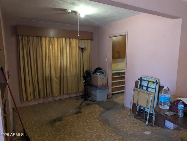 a bedroom with a workspace and a window