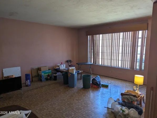 a living room with furniture and a lamp