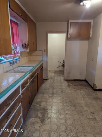 a kitchen with sink and refrigerator